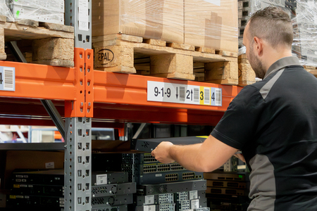 Man sorting IT hardware on a shelf